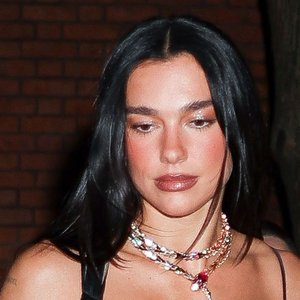 Dua Lipa Turns Heads in Daring Sheer Minidress with Feather Trim